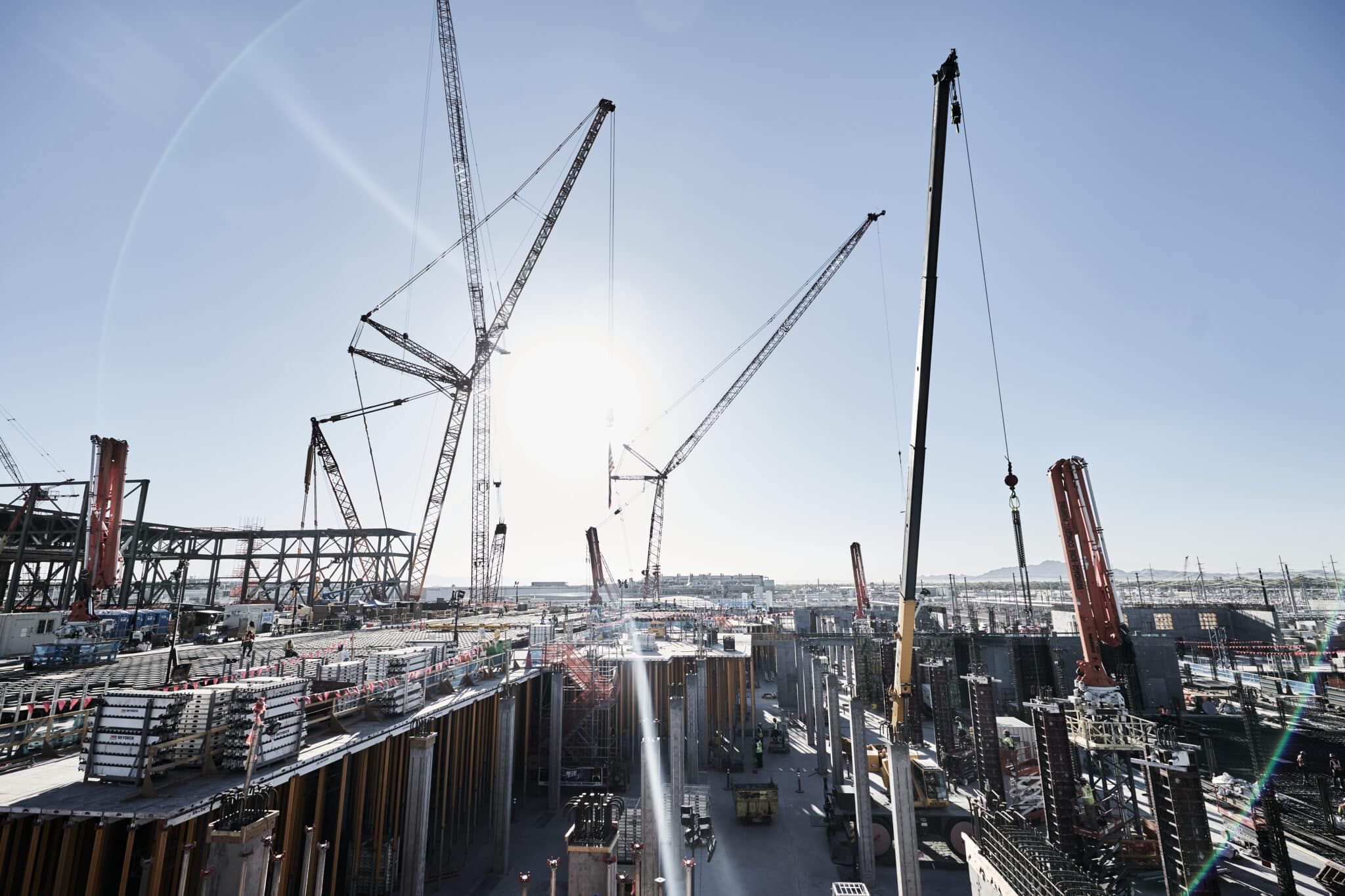 Steel and concrete infrastructure construction with cranes